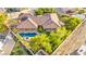 Aerial view showcasing the property's expansive lot, private pool, and lush landscaping at 5680 N Fort Apache Rd, Las Vegas, NV 89149