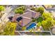 Aerial view of a home with a tile roof, solar panels, lush landscaping, a pool and an attached spa at 5680 N Fort Apache Rd, Las Vegas, NV 89149