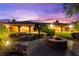 Inviting backyard featuring a fire pit, spa, and lush landscaping perfect for outdoor entertaining at 5680 N Fort Apache Rd, Las Vegas, NV 89149