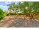 Beautifully landscaped backyard with stone pathways and mature trees, providing a peaceful and private setting at 5680 N Fort Apache Rd, Las Vegas, NV 89149