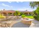 Expansive backyard featuring a cozy fire pit and lush landscaping, creating a serene outdoor retreat at 5680 N Fort Apache Rd, Las Vegas, NV 89149