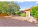 Charming backyard with gravel and stone accents, surrounded by lush greenery for added privacy and tranquility at 5680 N Fort Apache Rd, Las Vegas, NV 89149