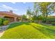 Spacious backyard with well-maintained lawn and mature trees, ideal for outdoor activities and enjoyment at 5680 N Fort Apache Rd, Las Vegas, NV 89149