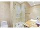 Elegant bathroom features a glass shower, travertine tile, and granite vanity at 5680 N Fort Apache Rd, Las Vegas, NV 89149