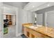 Bright bathroom boasts a granite countertop and a view into the home office at 5680 N Fort Apache Rd, Las Vegas, NV 89149