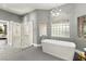 Bright bathroom featuring a soaking tub, glass shower, and modern fixtures at 5680 N Fort Apache Rd, Las Vegas, NV 89149