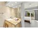 Bright bathroom with a modern vanity and glass door to the bedroom's patio at 5680 N Fort Apache Rd, Las Vegas, NV 89149