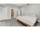 Bedroom features a wood bed frame, gray walls, and doorways to the bathroom and other rooms at 5680 N Fort Apache Rd, Las Vegas, NV 89149