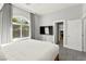 Comfortable bedroom features an arched window, gray walls and curtains, and a wall-mounted television at 5680 N Fort Apache Rd, Las Vegas, NV 89149