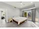 Bright bedroom features a ceiling fan, sliding glass doors, and doorways to other rooms at 5680 N Fort Apache Rd, Las Vegas, NV 89149