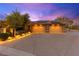 Home with solar panels, three-car garage, meticulous landscaping, and driveway for ample parking at 5680 N Fort Apache Rd, Las Vegas, NV 89149