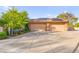 Home exterior featuring a spacious three-car garage, complemented by solar panels for energy efficiency at 5680 N Fort Apache Rd, Las Vegas, NV 89149