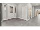 Bright foyer featuring stylish tile flooring, a decorative front door, and ample natural light at 5680 N Fort Apache Rd, Las Vegas, NV 89149