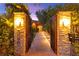 Welcoming front entrance featuring a custom gate and manicured landscaping for added privacy at 5680 N Fort Apache Rd, Las Vegas, NV 89149