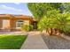 Charming home featuring a well-manicured front yard with lush landscaping and inviting curb appeal at 5680 N Fort Apache Rd, Las Vegas, NV 89149