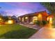 Charming home with manicured lawn, paved walkway, decorative seating, and privacy landscaping at 5680 N Fort Apache Rd, Las Vegas, NV 89149