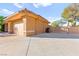 Home exterior showcasing a three-car garage and expansive driveway, providing ample parking space at 5680 N Fort Apache Rd, Las Vegas, NV 89149