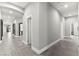 Long hallway with modern tile flooring, recessed lighting, and arched doorways at 5680 N Fort Apache Rd, Las Vegas, NV 89149