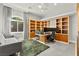 Home office features a large window with gray curtains, custom cabinetry and dual monitors at 5680 N Fort Apache Rd, Las Vegas, NV 89149
