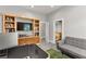 Open home office with built-in bookcase, sofa and doorway to the bathroom at 5680 N Fort Apache Rd, Las Vegas, NV 89149