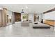 Spacious, neutral living room with modern furniture, fireplace and ample natural light streaming through expansive windows at 5680 N Fort Apache Rd, Las Vegas, NV 89149