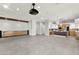 Spacious living room with projector and sleek kitchen with modern appliances at 5680 N Fort Apache Rd, Las Vegas, NV 89149