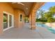 Inviting covered patio with view of the lush backyard and sparkling pool at 5680 N Fort Apache Rd, Las Vegas, NV 89149
