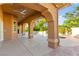 Covered patio with view of the luxurious pool and landscaped backyard at 5680 N Fort Apache Rd, Las Vegas, NV 89149