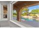 Inviting backyard pool and spa area with lush landscaping and covered patio, seen from inside at 5680 N Fort Apache Rd, Las Vegas, NV 89149
