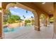 Stunning view of the pool, spa, and covered patio from the backyard at 5680 N Fort Apache Rd, Las Vegas, NV 89149