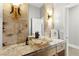 Stylish powder room showcasing decorative lighting, vessel sink and marble-look counter at 5680 N Fort Apache Rd, Las Vegas, NV 89149