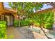 Landscaped courtyard view features an outdoor water feature and mature trees by the front entrance at 5680 N Fort Apache Rd, Las Vegas, NV 89149