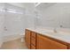 A well-lit bathroom featuring double sinks and a shower and tub combo at 6041 Rosanna St, Las Vegas, NV 89113