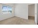 Bedroom with light carpet, closet, and a view from the window at 6041 Rosanna St, Las Vegas, NV 89113