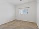 A bright bedroom with neutral carpet and a window offering a view of the outdoors at 6041 Rosanna St, Las Vegas, NV 89113