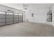 Spacious garage with an automatic door, concrete flooring, and utility sink at 6041 Rosanna St, Las Vegas, NV 89113