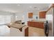 Kitchen featuring stainless steel appliances, wood cabinetry, granite countertops and tile flooring at 6041 Rosanna St, Las Vegas, NV 89113