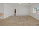Spacious living room with neutral carpet, white walls, and bright window creates a welcoming and airy atmosphere at 6041 Rosanna St, Las Vegas, NV 89113