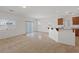 Open concept living room flows into kitchen, with tile flooring, breakfast bar, and abundant natural light at 6041 Rosanna St, Las Vegas, NV 89113