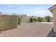 Gravel backyard featuring storage, seating and views of neighborhood homes at 6209 Lenaking Ave, Las Vegas, NV 89122