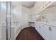 Bright bathroom with double vanity, dark wood floors, and separate tub and shower at 6209 Lenaking Ave, Las Vegas, NV 89122