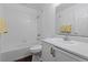 Clean bathroom featuring a shower-tub combo with white tile surround and white vanity at 6209 Lenaking Ave, Las Vegas, NV 89122