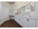 Bright bathroom with double vanity, dark wood floors, and separate tub and shower at 6209 Lenaking Ave, Las Vegas, NV 89122
