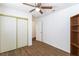 Bedroom featuring a bookcase, closet with sliding doors, and wood-look flooring at 6209 Lenaking Ave, Las Vegas, NV 89122
