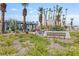 Landscaped community entrance with desert vegetation and Palm Gardens signage at 6209 Lenaking Ave, Las Vegas, NV 89122