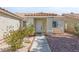 Inviting front entrance of a home with manicured landscaping and a charming walkway leading to the front door at 6209 Lenaking Ave, Las Vegas, NV 89122