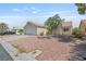 Single-story home with desert landscaping showcasing its two-car garage and easy to maintain front yard at 6209 Lenaking Ave, Las Vegas, NV 89122