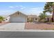 Charming single-story home with a two-car garage, complemented by low maintenance landscaping and a tiled roof at 6209 Lenaking Ave, Las Vegas, NV 89122