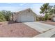 Single-story home featuring a two-car garage, low-maintenance landscaping, and a tiled roof, perfect for easy living at 6209 Lenaking Ave, Las Vegas, NV 89122