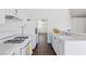 Kitchen features white cabinets, a breakfast bar, and appliances at 6209 Lenaking Ave, Las Vegas, NV 89122